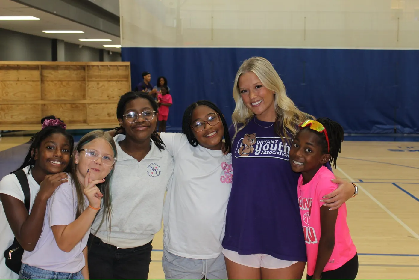 Bryant Youth Association mentor in a purple BYA shirt with a group of girls in Bryant, AR