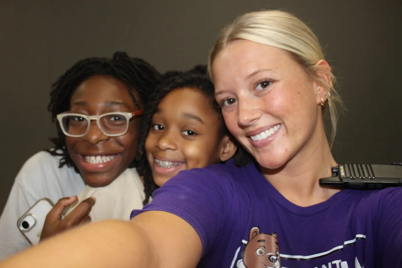 Bryant Youth Association staff member taking a selfie with two smiling girls in Bryant, AR