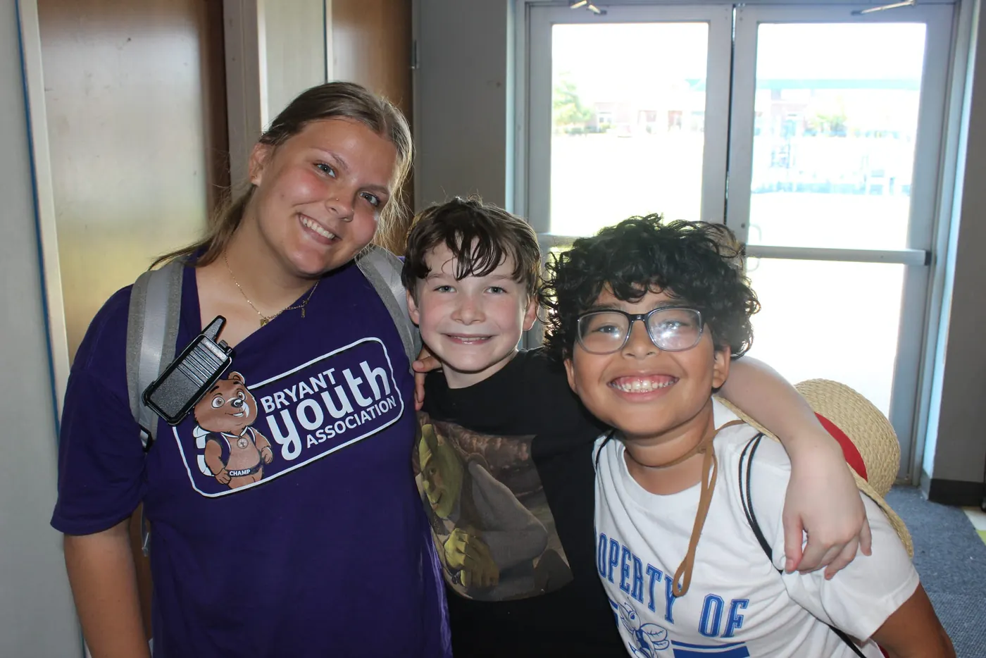 Bryant Youth Association volunteer mentor with two boys at the after school program in Bryant, AR